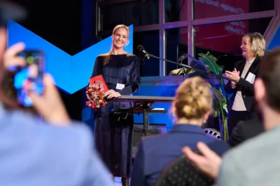 Innovationspreis Berlin Brandenburg: Gerührte Preisträgerin bei Applaus; Eventfotografie Stefan Schubert.